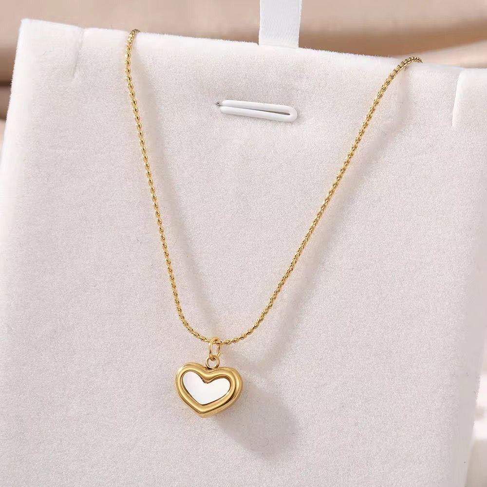 White heart necklace with a gold-toned chain