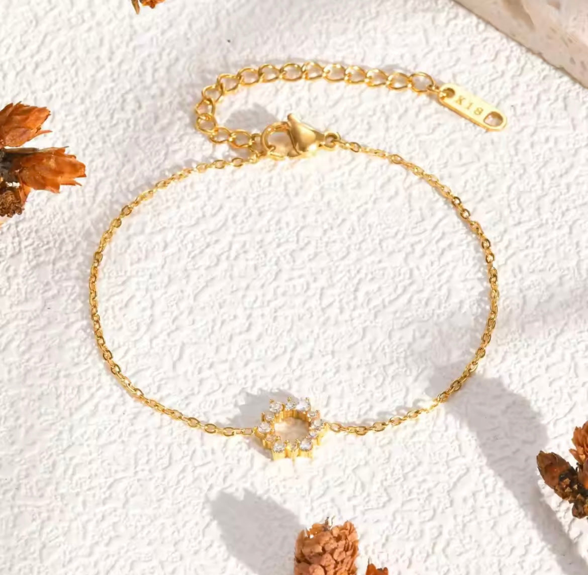 Elegant gold tennis bracelet with emerald cut center stone