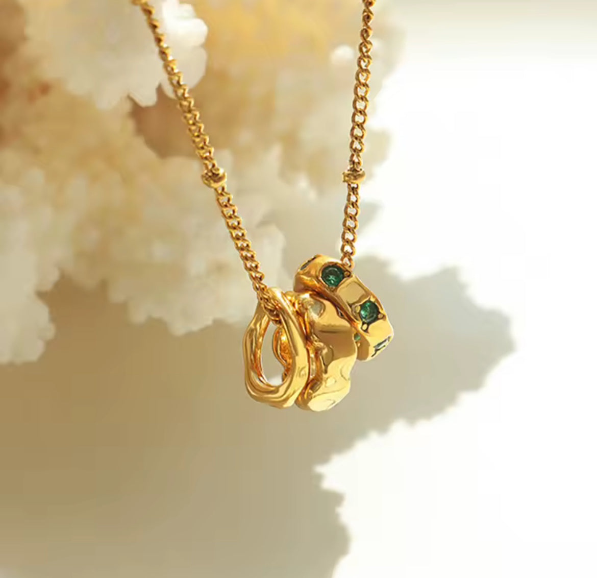Gold Interlocking Necklace with Emerald Crystal Accents