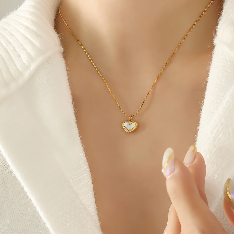 White heart necklace with a gold-toned chain