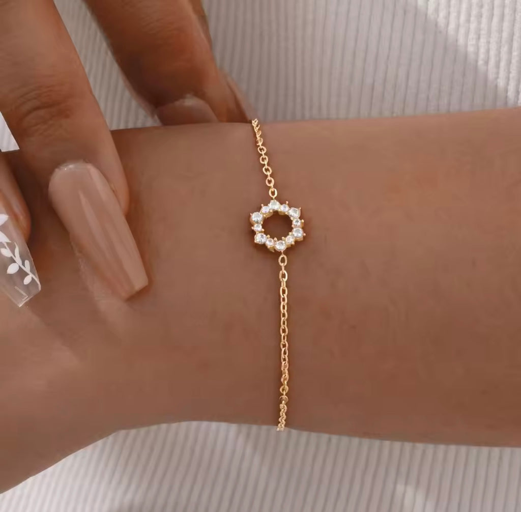 Elegant gold tennis bracelet with emerald cut center stone