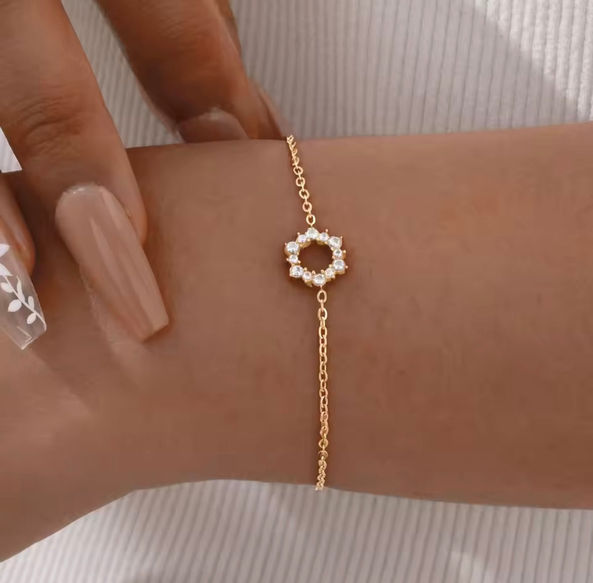 Elegant gold tennis bracelet with emerald cut center stone