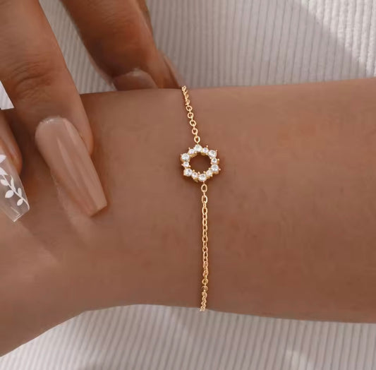 Elegant gold tennis bracelet with emerald cut center stone