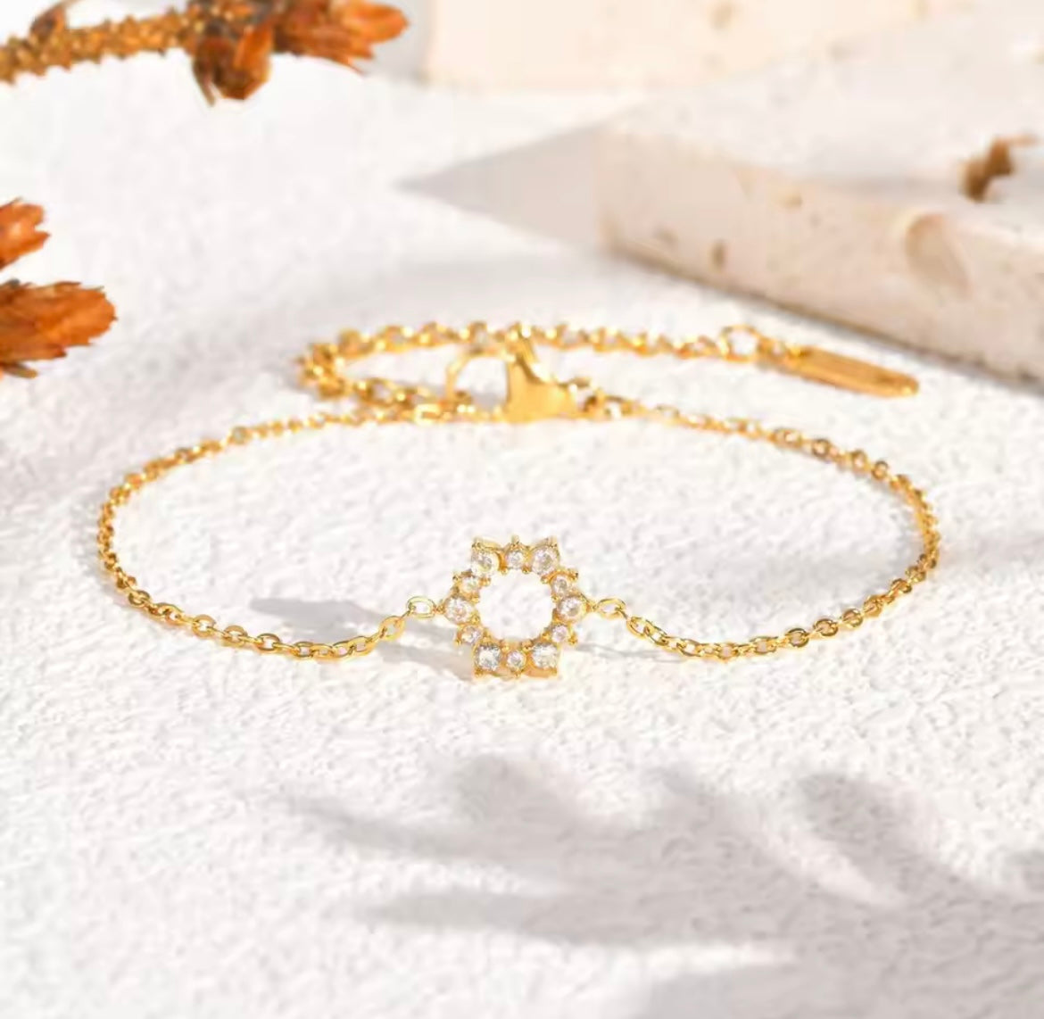 Elegant gold tennis bracelet with emerald cut center stone