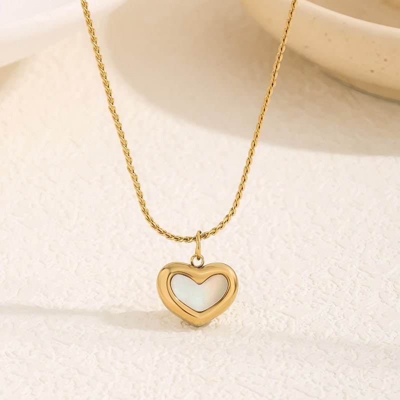 White heart necklace with a gold-toned chain