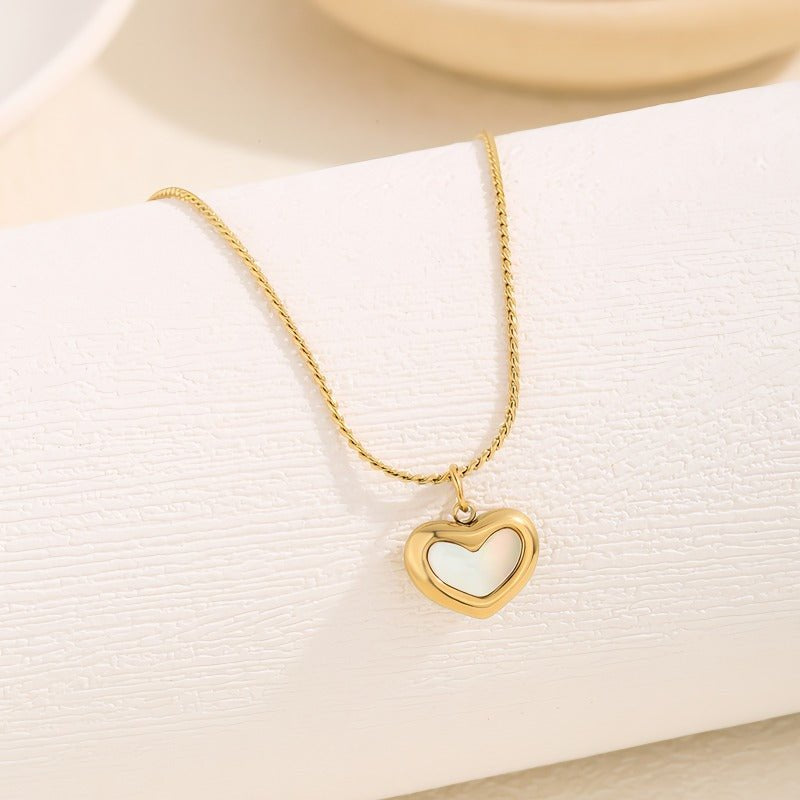 White heart necklace with a gold-toned chain