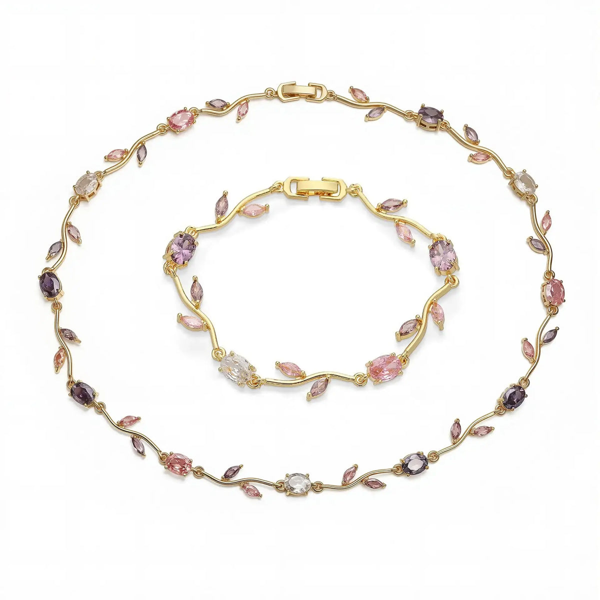 Gold bracelet with pink and purple gemstones on a white background
