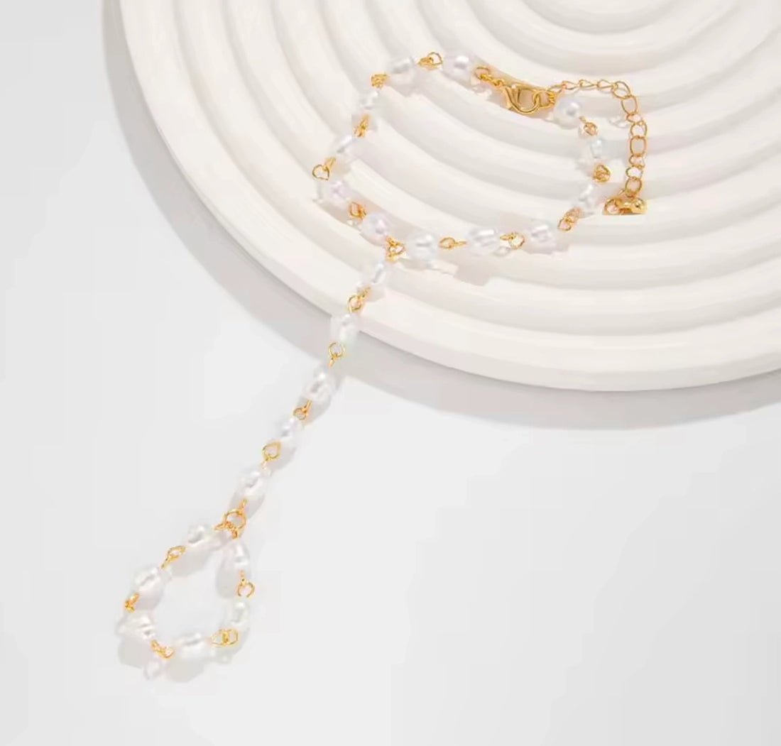 Beautiful white pearl finger bracelet accessory for women showcasing timeless pearl elegance and sophistication