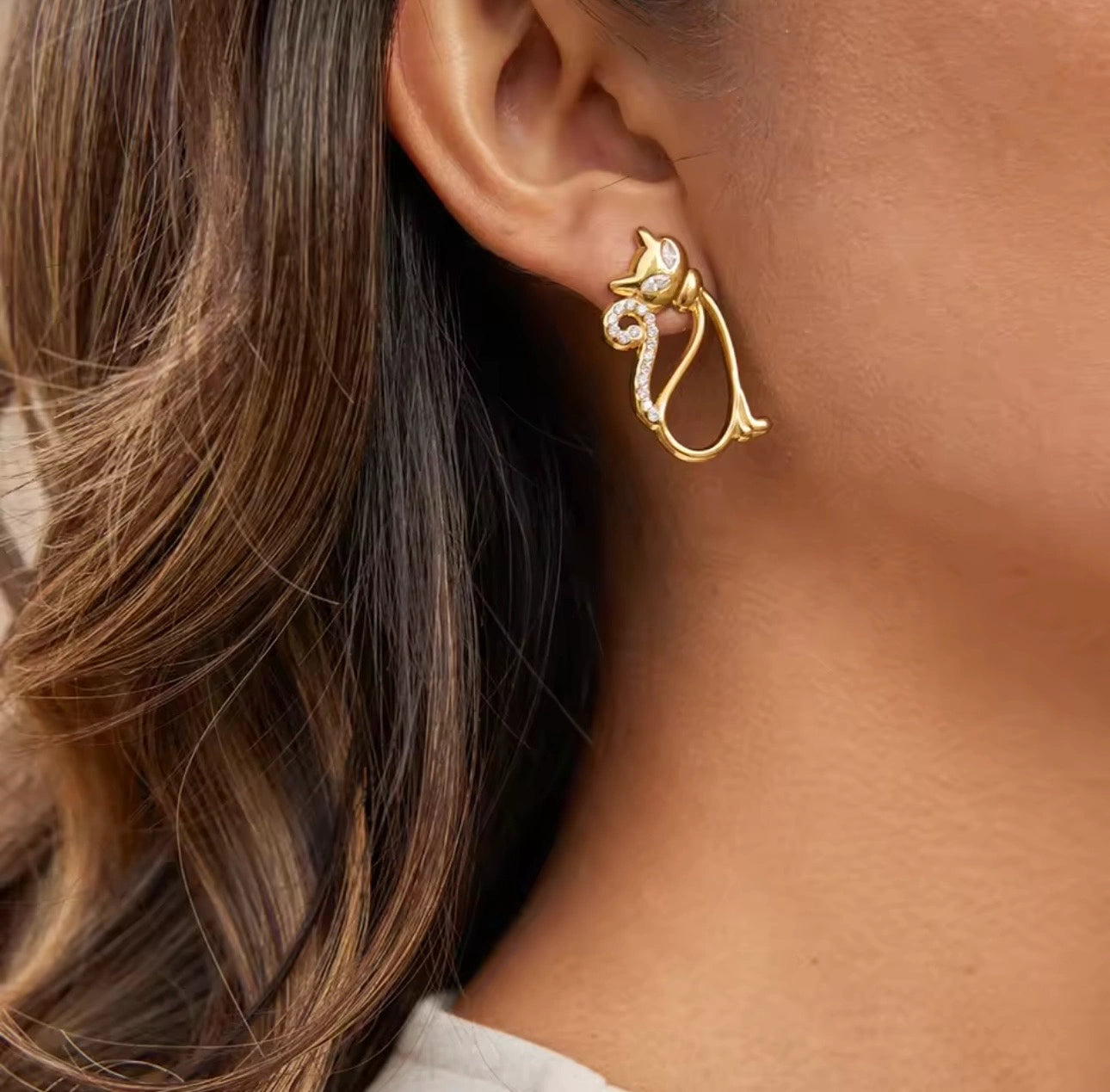 Woman wearing Meow Studs cat earrings look
